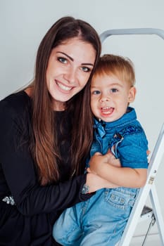 mother and young son on the stairs stepladder 1