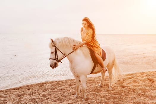 A woman in a dress stands next to a white horse on a beach, with the blue sky and sea in the background