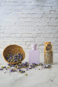 A studio photo of lavender flower and perfume on table .