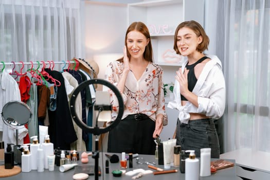 Woman influencer shoot live streaming vlog video review makeup utmost social media or blog. Happy young girl with cosmetics studio lighting for marketing recording session broadcasting online.