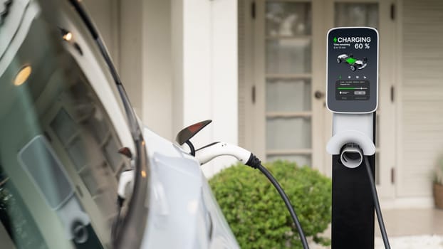 Electric vehicle technology utilized to residential area or home charging station for EV car battery recharge. Eco-friendly transport by clean and sustainable energy for future environment. Synchronos