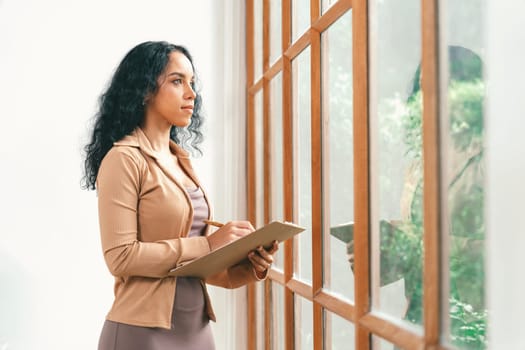 Psychologist woman in clinic office professional portrait with friendly smile feeling inviting for patient to visit the psychologist. The experienced and confident psychologist is crucial specialist