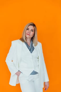 Adult woman in white suit on orange background