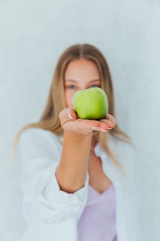 woman holding two green apples in her hands