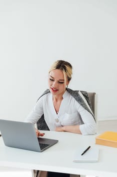 woman in office working on laptop online