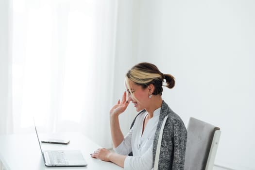 woman in office chatting online on laptop