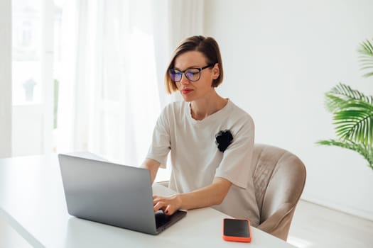 woman working on laptop in office finance online