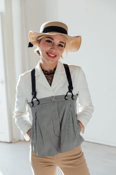 Portrait of a beautiful young woman in summer suit and hat