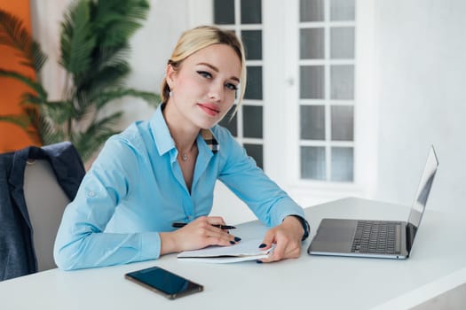 woman working on laptop in office finance online