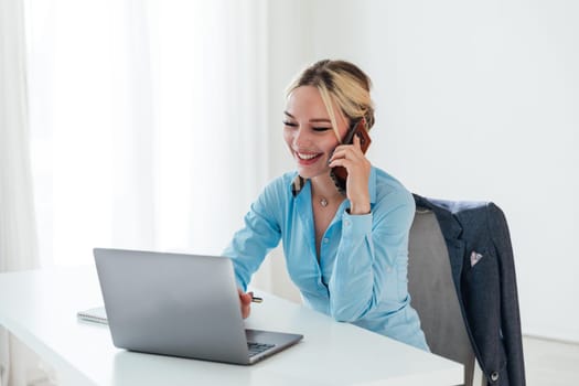 woman conducting financial negotiations online on phone and laptop