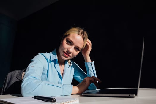 woman working on laptop in office finance online