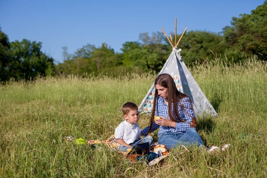 mom with her son on a picnic rest in nature