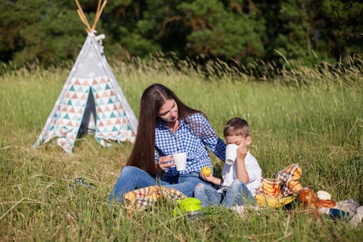 mom with her son on a picnic rest in nature