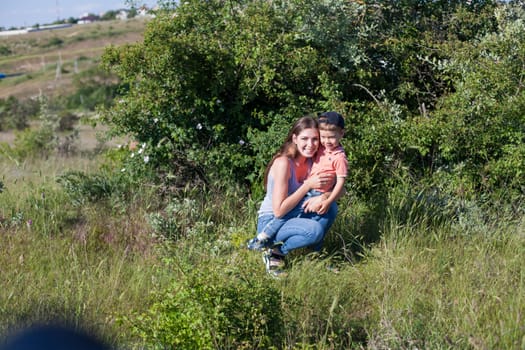 mom with her son on a picnic rest in nature