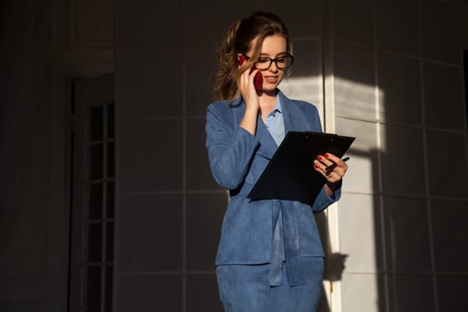 Beautiful woman in business suit talks in the office