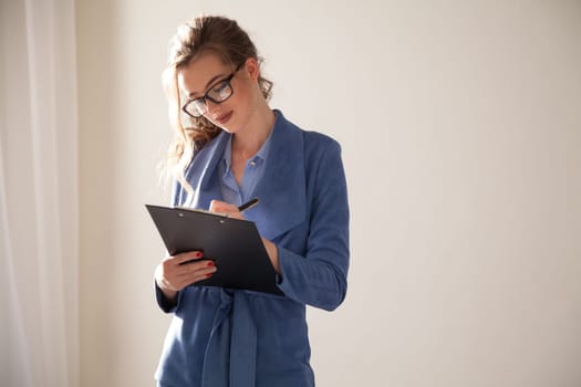 Beautiful woman in business suit talks in the office