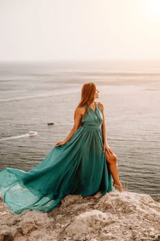 Woman sea trevel green dress. Side view a happy woman with long hair in a long mint dress posing on a beach with calm sea bokeh lights on sunny day. Girl on the nature on blue sky background