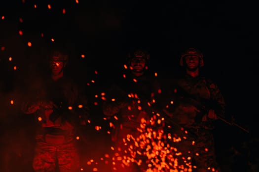 Soldiers squad in action on night mission using laser sight beam lights military team concept.