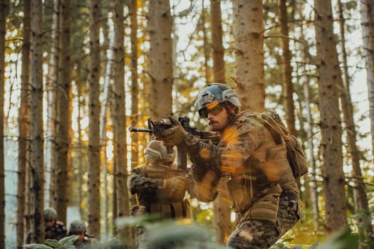 A group of modern warfare soldiers is fighting a war in dangerous remote forest areas. A group of soldiers is fighting on the enemy line with modern weapons. The concept of warfare and military conflicts.