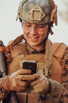 Soldier using smartphone to contact family or girlfriend communication and nostalgia concept.