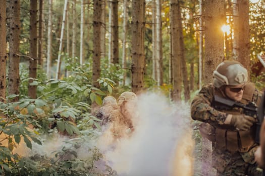 A group of modern warfare soldiers is fighting a war in dangerous remote forest areas. A group of soldiers is fighting on the enemy line with modern weapons. The concept of warfare and military conflicts.