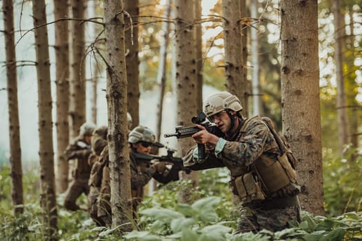 A group of modern warfare soldiers is fighting a war in dangerous remote forest areas. A group of soldiers is fighting on the enemy line with modern weapons. The concept of warfare and military conflicts.