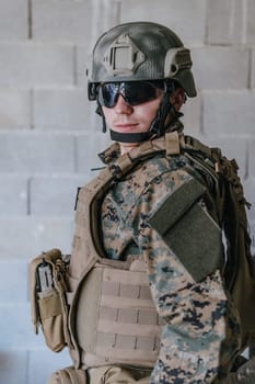 Soldier preparing tactical protective and communication gear for action battle.