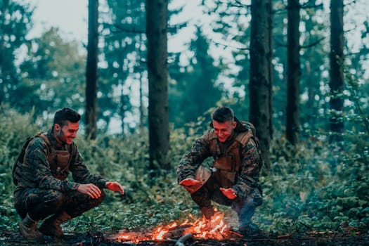 Two exhausted soldiers sitting by the fire after a weary and heavy war battle.