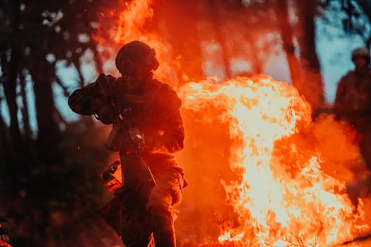 Soldier in Action at Night in the Forest Area. Night Time Military Mission jumping over fire.