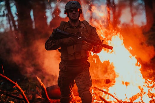 Soldier in Action at Night in the Forest Area. Night Time Military Mission jumping over fire.