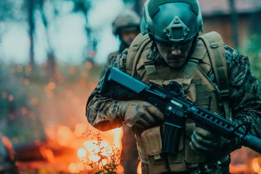 Soldier in Action at Night in the Forest Area. Night Time Military Mission jumping over fire.