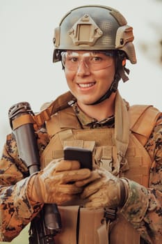 Soldier using smartphone to contact family or girlfriend communication and nostalgia concept.