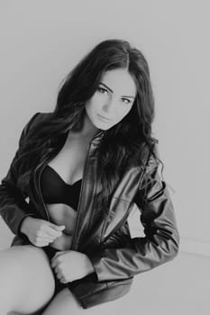 brunette girl in fancy leather jacket and black lingerie