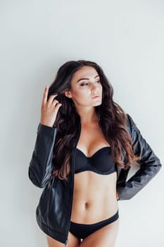 brunette girl in fancy leather jacket and black lingerie