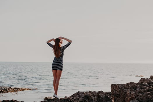 girl on the rocky beach looks at sea 1