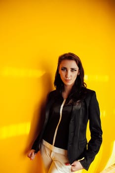 beautiful stylish girl by the yellow wall 1