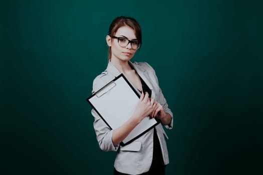 teacher with papers in green boards 1 2