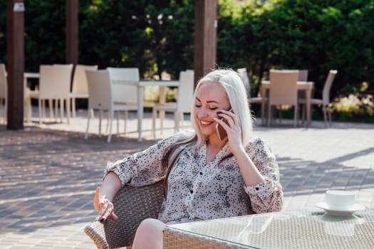 nice girl at the beach restaurant talking on the phone