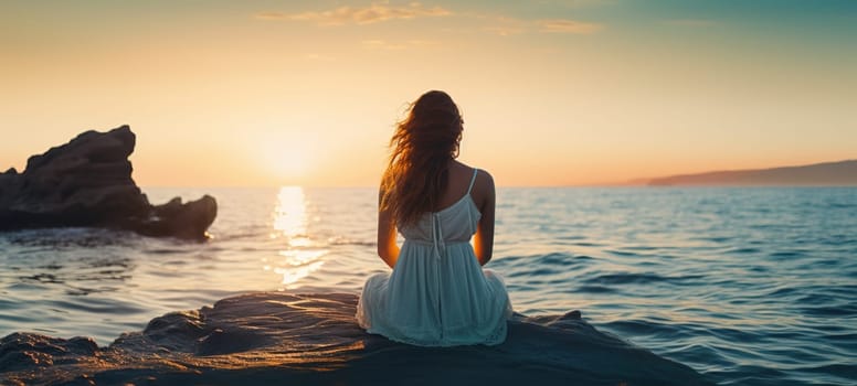 a young woman in a white dress sadly sits on a rock by the sea, all alone and looks at the dawn on the horizon, central composition, view from the back, psychology concept, high quality photo