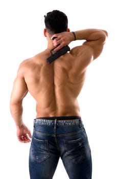 A shirtless muscular man with his back to the camera, holding a gun, isolated on white in studio shot