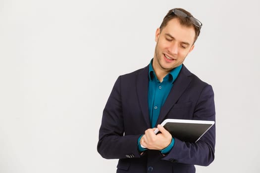 Cheerful businessman touching digital tablet on white background