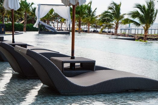 Image of Chaise longue at the pool in tropical resort