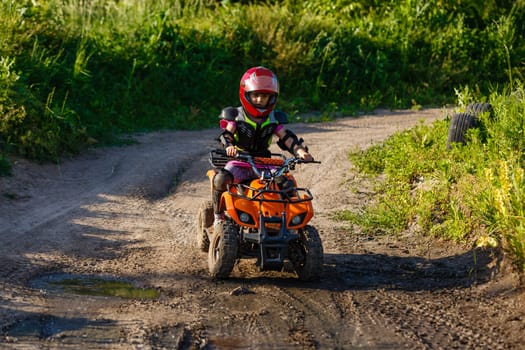 Girl riding an electric quad bike.