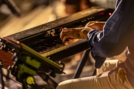 Close-up of a pianist's hands playing passionately in a foggy and atmospheric night concert.