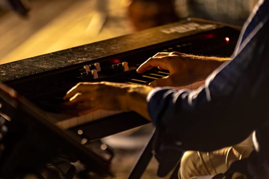 Close-up of a pianist's hands playing passionately in a foggy and atmospheric night concert.