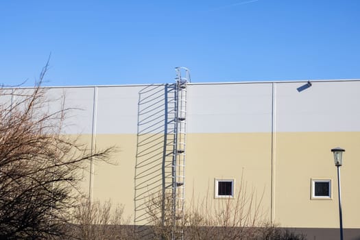 Staircase to the roof of an industrial building, blue sky