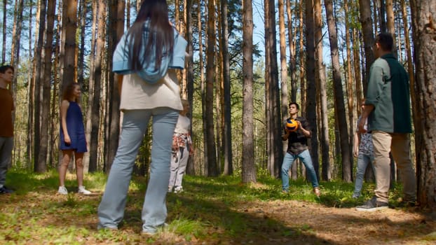 Friends have fun playing volleyball. Stock footage. Friends are emotionally playing volleyball. Vivid emotions of people from playing volleyball in nature.