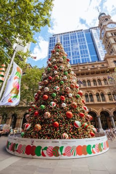 SYDNEY, AUSTRALIA DECEMBER 3 2023: Martin Place with Christmas tree, lights and decorations in the middle of a busy day in Sydney CBD, New South Wales, Australia