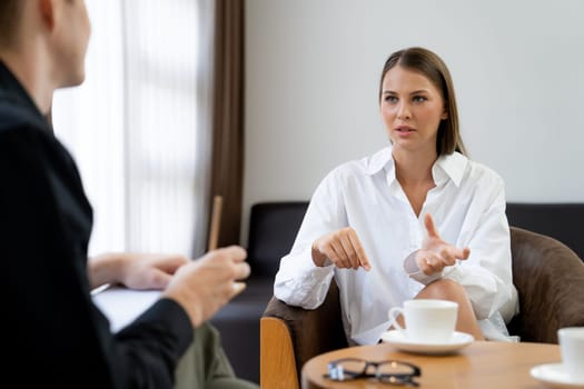Psychological consultation gaining improvement on mental problem, happy young female patient doing therapy session while psychiatrist making diagnostic on mental illness. Unveiling