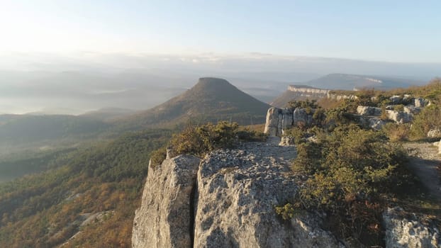 View from the cliff on a mountain, mountain, above the clouds. Autumn mountain landscape